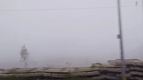 Dolly view from moving train through foggy landscape showing misty nature a.. Stock Footage 334793372