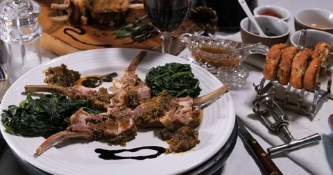 Dolly view of a rack of lamb with crusted mint sauce and mashed potatoes Stock Footage 74068227