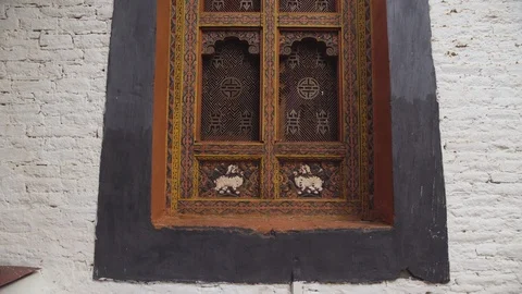 Dolly zoom out of a window inside Punakha Dzong in bhutan Stock Footage 104967426
