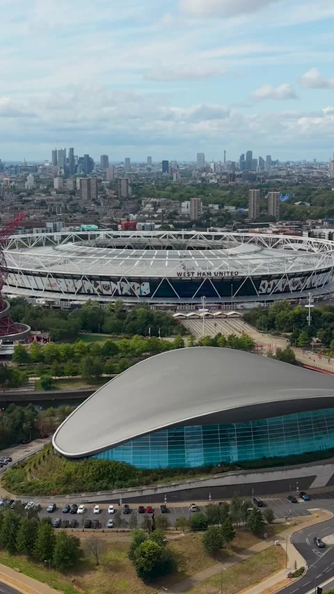 Dolly zoom vertical view of West Ham stadium and London Aquatics Centre in Stock Footage 345723222