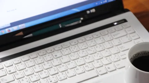 Dolly:workdesk Notepad, laptop and coffee cup on wood table footage Video stock 50418798