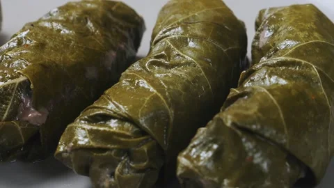 Dolma with beef grape leaves rotates on a gray plate in a circle. Close-up. 库存影片 297996665