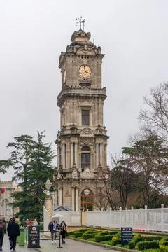 Dolmabahe Palace clock tower stands tall against a cloudy sky in Istanbul Stock Photos