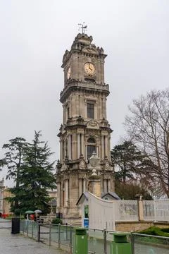 Dolmabahe Palace clock tower stands tall against a cloudy sky in Istanbul Stock Photos