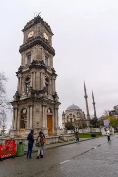 Dolmabahe Palace clock tower stands tall against a cloudy sky in Istanbul Stock Photos