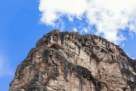Dolomite rock peak with typical texture and color against blue sky Stock Photos