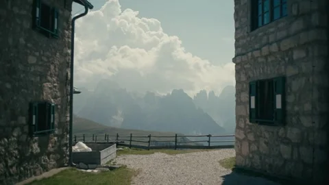 Dolomites Mountain Scenery Viewed from Between Rustic Stone Mountain Huts 库存影片 331169856