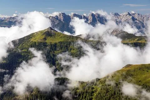 Dolomites mountains in the middle of Clouds Stock Photos