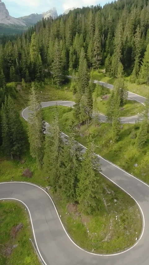 Dolomites winding forest mountain pathway, serpentine mountain road amid lush Stockbeeldmateriaal 323336558