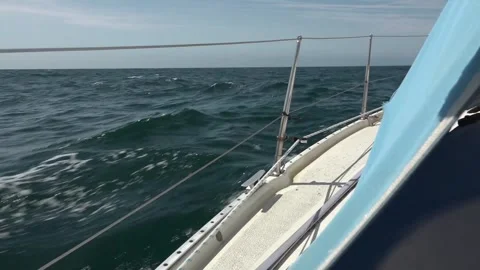 Dolphin breaching by the side of Albin Ballad yacht in the English Channel Stock Footage 255837158