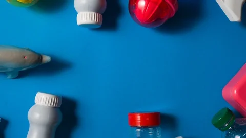 Dolphin is chased by different container of plastic over an aqua bacground 動画素材 105725417
