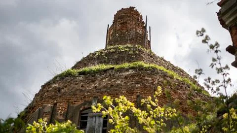 Dome of an ancient red brick temple. Ruins of an Orthodox Church against a bl Stock Photos