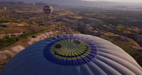 Dome of balloon with image of a smile on background of hills and other balloons Stock Footage 105237906