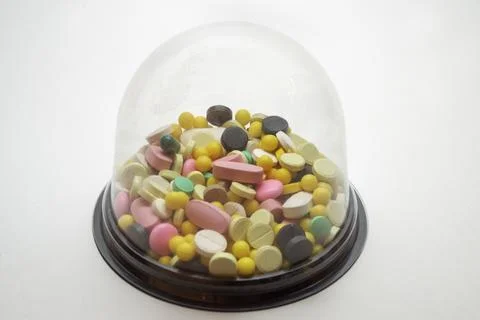 Dome box for mini cupcake, full of pills, tablets and multicolored small vi.. Stock Photos