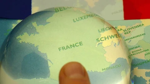 Dome magnifier pushed across a map, highlighting France. Video stock 70018053