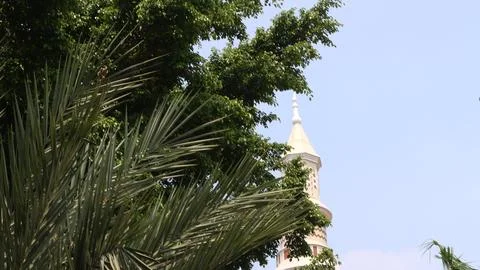 The dome of the mosque is covered by trees Stock Photos