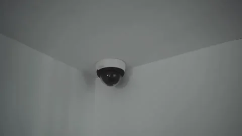 Dome security camera with green indicator light in corner of room. Stock Footage 337417813