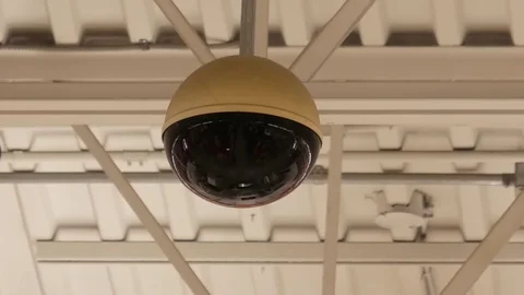 Dome security camera on top of ceiling inside store with 4k resolution Stock Footage 79841571