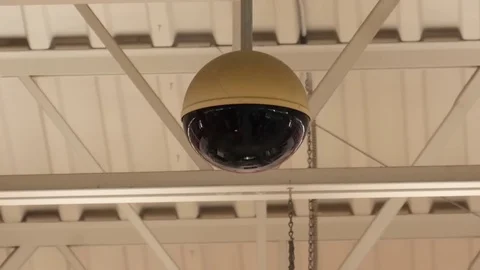 Dome security camera on top of ceiling inside store with 4k resolution Stock Footage 79844084