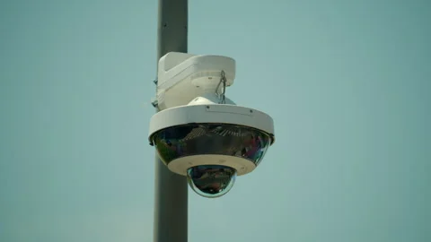Dome-shaped cctv surveillance camera mounted on a pole, providing security and Stock Footage 339814580