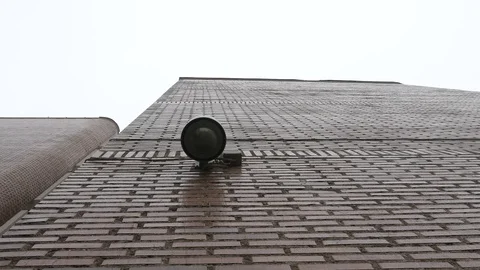 Dome surveillance camera on the school building recorded from below Stock Footage 106028214