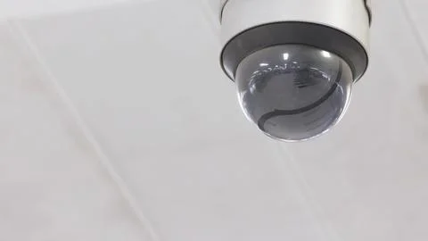 Dome type CCTV surveillance security camera install on ceiling to monitor the Stock Photos