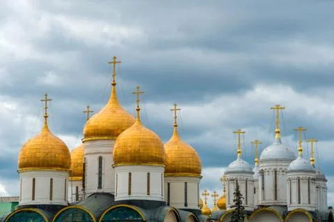 Domes of churches of the Moscow Kremlin on a background of a stormy sky Stock Photos