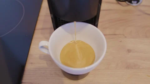 Domestic coffee machine brews aromatic coffee close-up. Each cup of aromatic Stock Footage 265015841