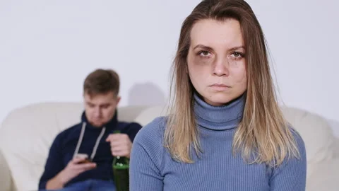 Domestic violence concept. Abused Young Woman with bruises on her face showing Stock Footage 100991653