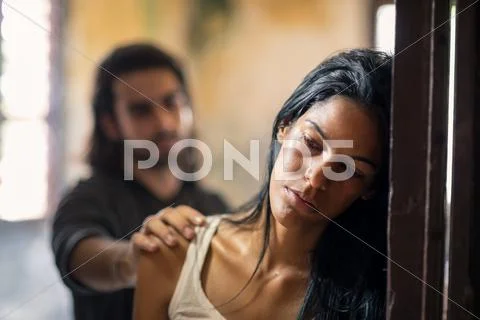 Domestic violence with young man and abused woman Stock Photos