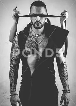 Dominat man. sexy abs of tattoo man. male fashion. female hands cover his eyes Stock Photos