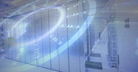 Dominating tall server cabinets casting cool LED light in data hall with cables Stock Photos