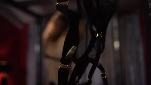 Dominatrix sit on the slave and moving her body in a sexy way Stock Footage 220928842