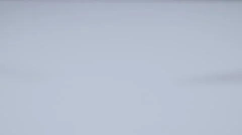 Domino falls down from above onto a white table slow motion Stock Footage 58761452
