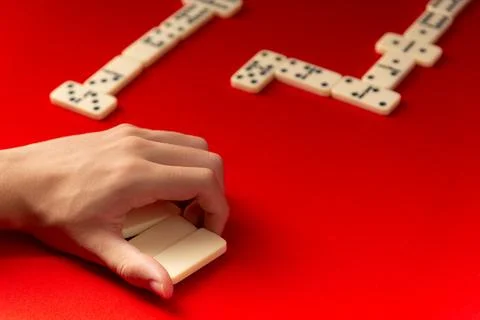 Domino player holding rectangular acrylic pieces. Board game. Stock Photos