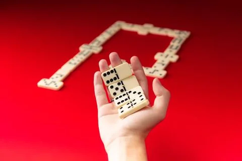 Domino player holding rectangular number acrylic pieces. Board game. 스톡 사진