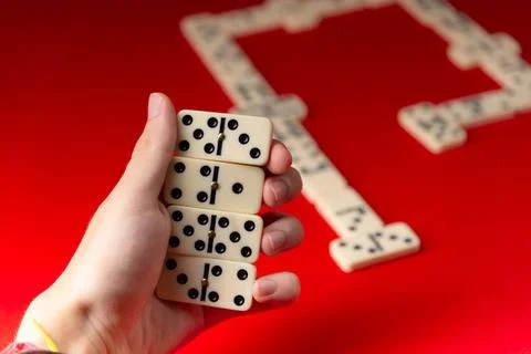  Domino player holding rectangular number acrylic pieces. Board game. Red ... Stock Photos