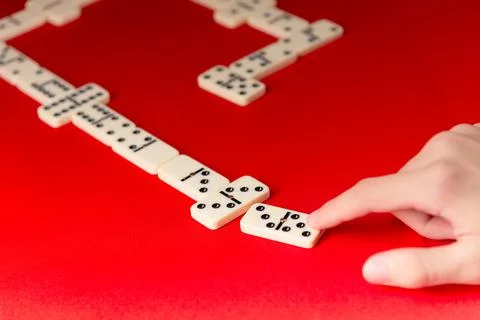 Domino players hand placing a rectangular acrylic tiles. Board game. 스톡 사진