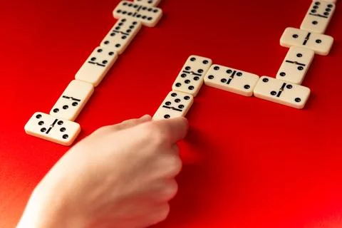 Domino players hand placing a rectangular acrylic tiles. Board game. 스톡 사진