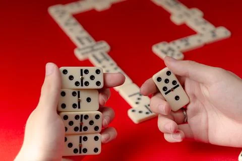 Domino players hands holding rectangular number blocks. Board game. 写真素材