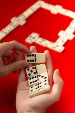 Domino players hands holding rectangular number blocks. Board game. 스톡 사진