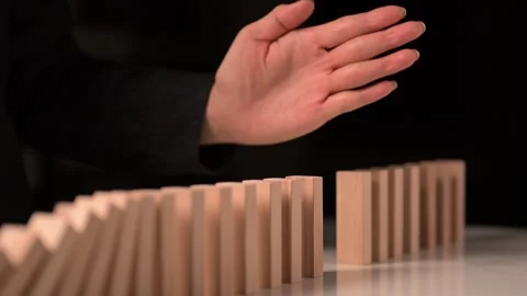 Domino Stopped By Hand Side view  Stock Footage 293334284