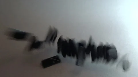Dominoes are falling down Stock Footage 98828817