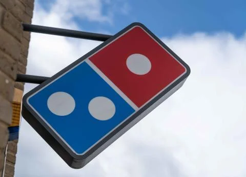 A Dominoes Pizza logo sign outside a restaurant in London Stock Photos
