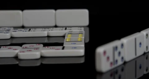Dominoes In Row on a black table Stock Footage 243396234