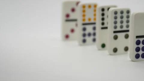 Dominos, A Hand Points at a Row of Falling Tiles Stock Footage 262499937