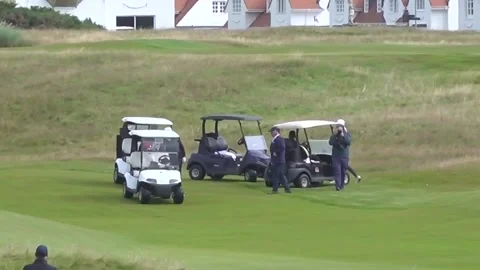 Donald Trump waves to cameras while golfing on private visit to Scotland Stock Footage 313790616