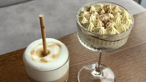 Donat with a cup of coffee in cafe on the table coffee and tiramisu on the table Stock Footage 322654568