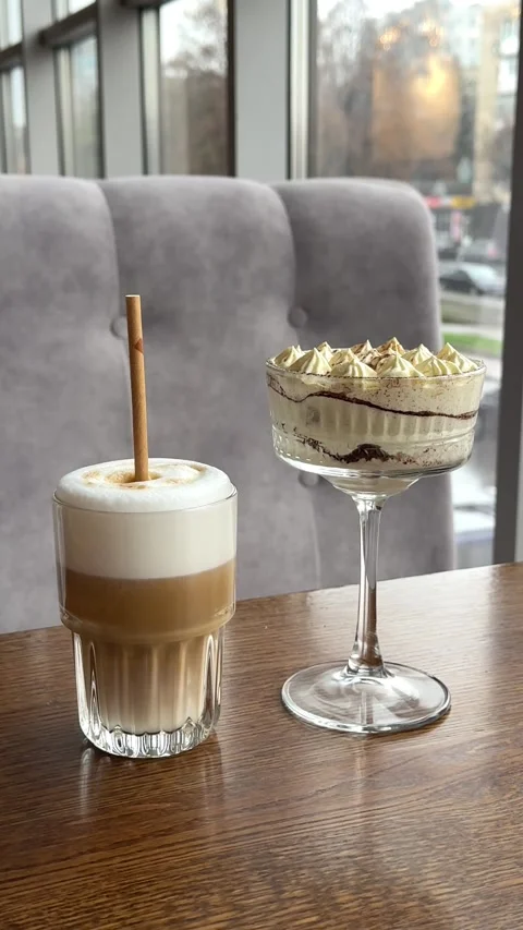 Donat with a cup of coffee in cafe on the table coffee and tiramisu on the table Stock Footage 322655173