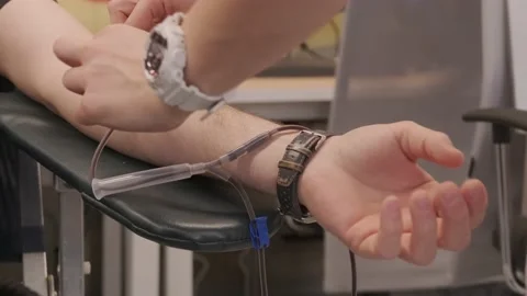 Donating blood and removing a needle into the arm Stock Footage 237002643